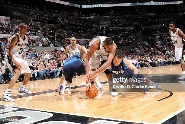 Tim Duncan of the San Antonio Spurs fights to grab the ball against Jose Juan Barea of the Dallas Mavericks in Game Six of the Western Conference...