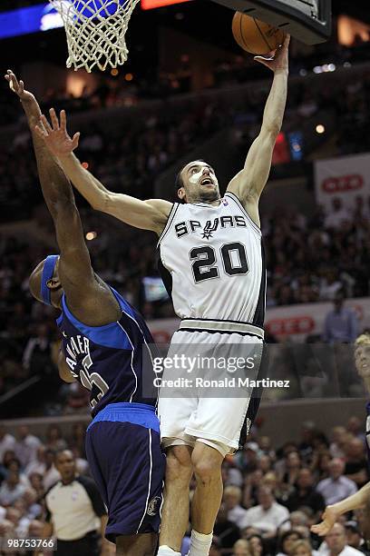 Guard Manu Ginobili of the San Antonio Spurs takes a shot against Erick Dampier of the Dallas Mavericks in Game Six of the Western Conference...