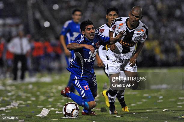 Jose Contreras of Universidad de Chile is fouled by Edgar Gonzalez of Peruvian Alianza Lima during their Copa Libertadores football match at Matute...