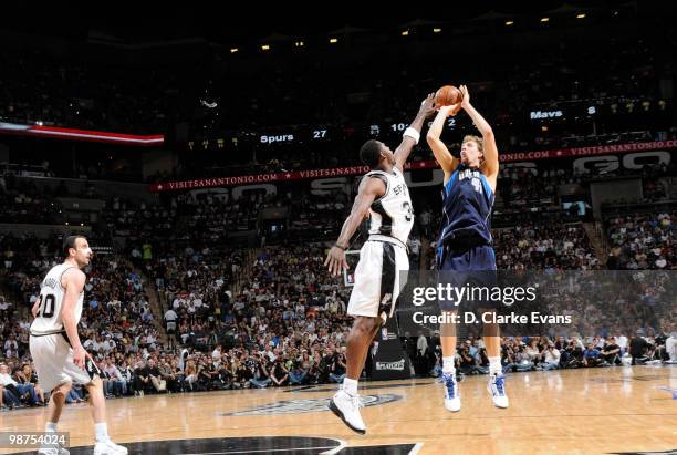 Dirk Nowitzki of the Dallas Mavericks shoots over Antonio McDyess of the San Antonio Spurs in Game Six of the Western Conference Quarterfinals during...