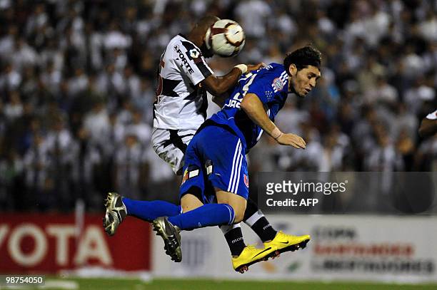 Jose Rojas of Universidad de Chile and Wilmer Aguirre of Peruvian Alianza Lima jump to head the ball during their Copa Libertadores football match at...