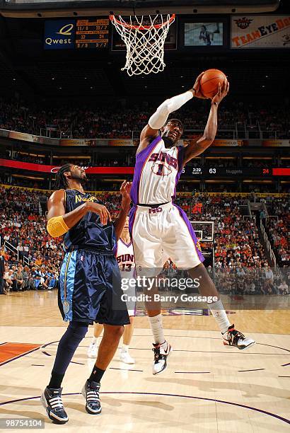 Amar'e Stoudemire of the Phoenix Suns controls the rebound over Nene of the Denver Nuggets at U.S. Airways Center on April 13, 2010 in Phoenix,...