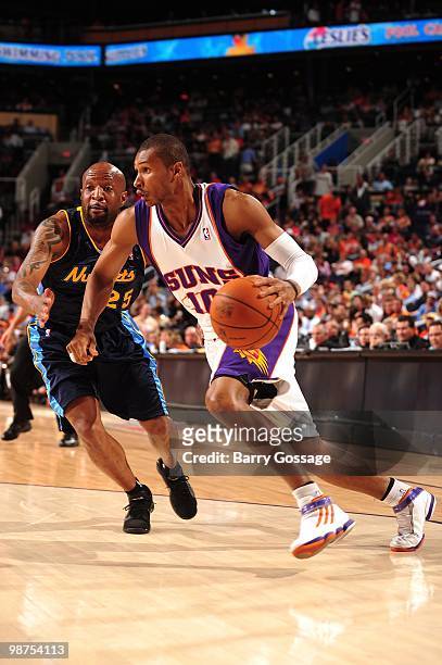 Leandro Barbosa of the Phoenix Suns drives past Anthony Carter of the Denver Nuggets at U.S. Airways Center on April 13, 2010 in Phoenix, Arizona....