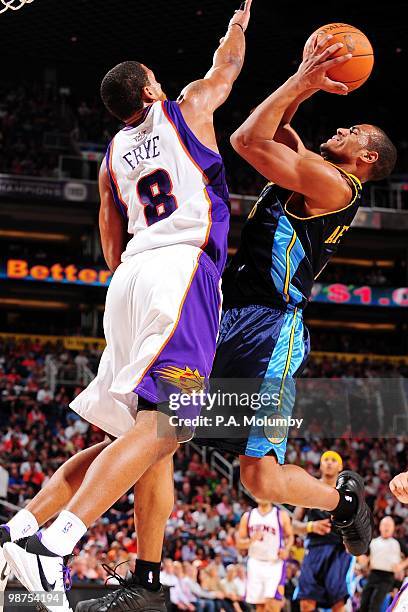 Arron Afflalo of the Denver Nuggets shoots against Channing Frye of the Phoenix Suns during the game at U.S. Airways Center on April 13, 2010 in...