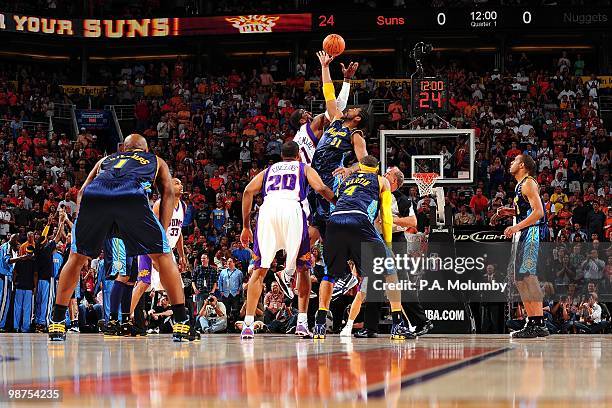 Nene of the Denver Nuggets and Amar'e Stoudemire of the Phoenix Suns tip off to start the game at U.S. Airways Center on April 13, 2010 in Phoenix,...