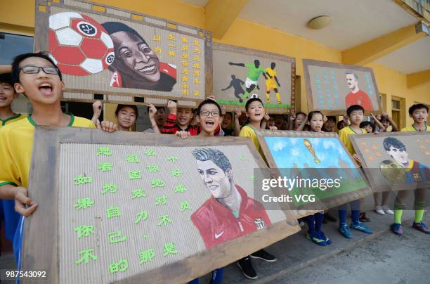 Students show their World Cup-themed handicrafts on discarded corrugated cardboards on June 27, 2018 in Handan, Hebei Province of China. A teacher...