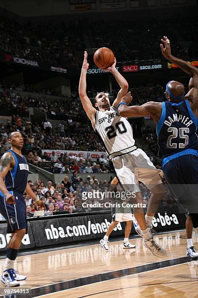 Manu Ginobili of the San Antonio Spurs shoots over Erick Dampier of the Dallas Mavericks in Game Six of the Western Conference Quarterfinals during...