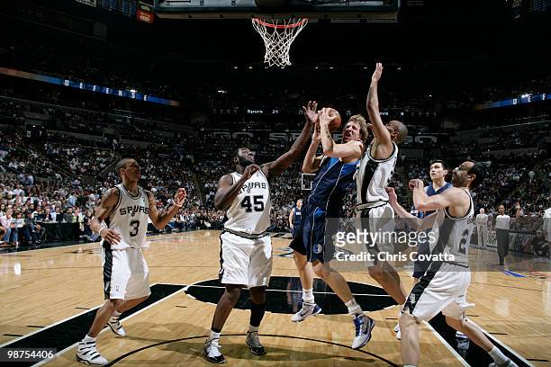 Dirk Nowitzki of the Dallas Mavericks shoots over Tony Parker and DeJuan Blair of the San Antonio Spurs in Game Six of the Western Conference...