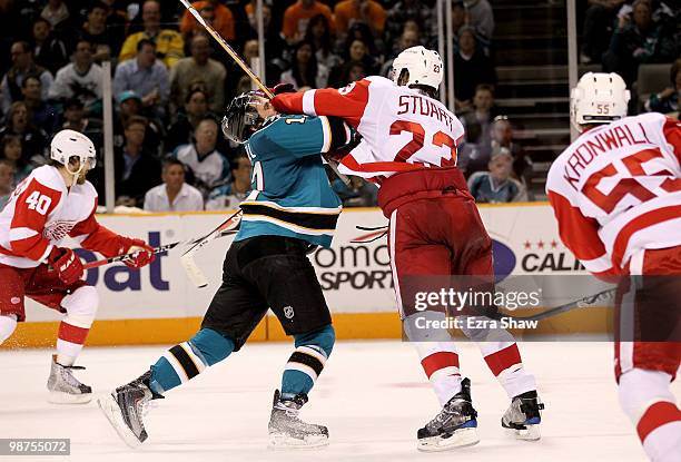 Torrey Mitchell of the San Jose Sharks gets hit by Brad Stuart of the Detroit Red Wings in Game One of the Western Conference Semifinals during the...