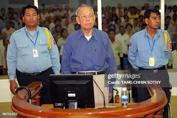 Former Khmer Rouge deputy prime minister and minister of foreign affairs Ieng Sary stands in the dock in the courtroom during a public hearing at the...