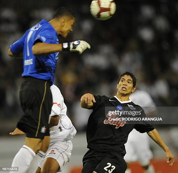 Rodolfo Gamarra of Paraguay's Libertad vies for the ball with goalkeepear Luis Martinez of Colombia's Once Caldas during their Libertadores Cup...