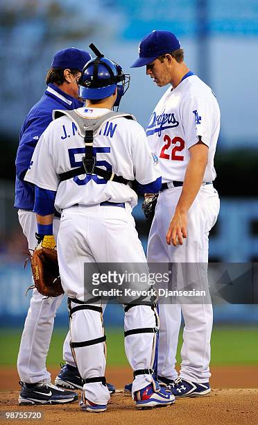Pitcher Clayton Kershaw of the Los Angeles Dodgers gets a visit from pitching coach Rick Honeycutt and catcher Russell Martin during the first inning...