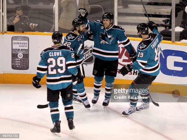 Joe Pavelski of the San Jose Sharks is congratulated by teammates after he scored a goal in the third period to give the Sharks a 4-2 lead over the...