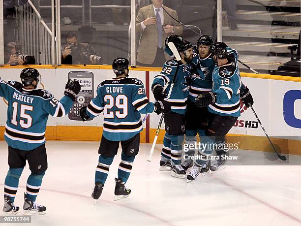 Joe Pavelski of the San Jose Sharks is congratulated by teammates after he scored a goal in the third period to give the Sharks a 4-2 lead over the...