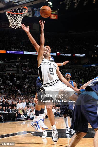 Tony Parker of the San Antonio Spurs shoots against Shawn Marion of the Dallas Mavericks in Game Six of the Western Conference Quarterfinals during...