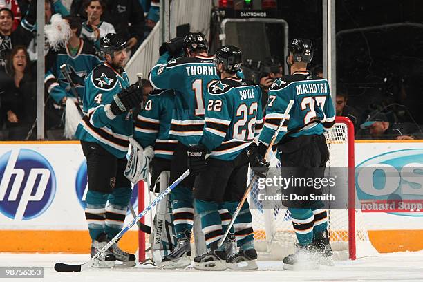 Evgeni Nabokov of the San Jose Sharks is congratulated by teammates Rob Blake, Joe Thornton, Dan Boyle and Manny Malhotra in Game One of the Western...