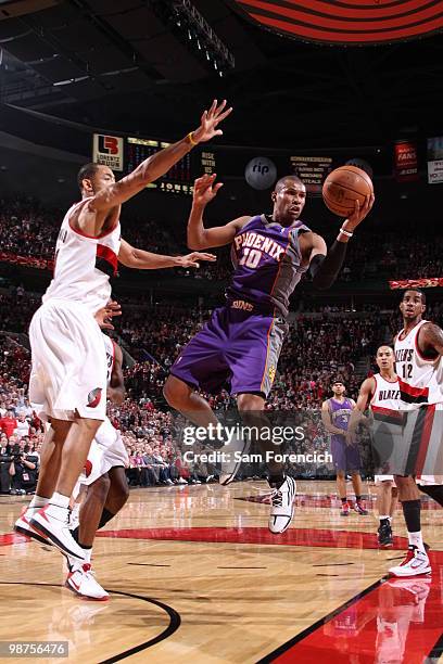 Leandro Barbosa of the Phoenix Suns looks for a pass around Juwan Howard of the Portland Trail Blazers in Game Six of the Western Conference...