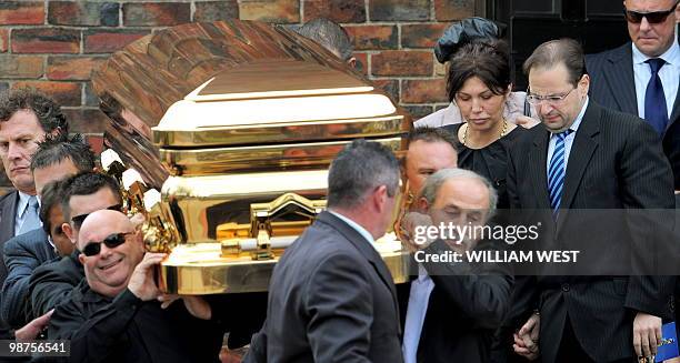 Roberta Williams , ex-wife of slain gangland killer Carl Williams, follows the gold-plated coffin out of the church as it leaves his funeral service,...