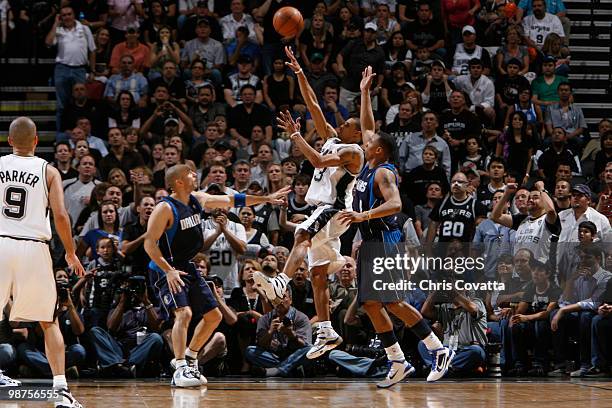 George Hill of the San Antonio Spurs shoots over Jason Kidd of the Dallas Mavericks in Game Six of the Western Conference Quarterfinals during the...
