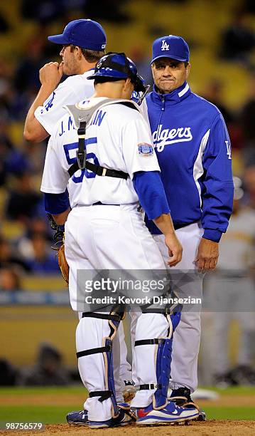Pitcher Clayton Kershaw of the Los Angeles Dodgers is yanked out of the game by manager Joe Torre as catcher Russell Martin looks on during the...
