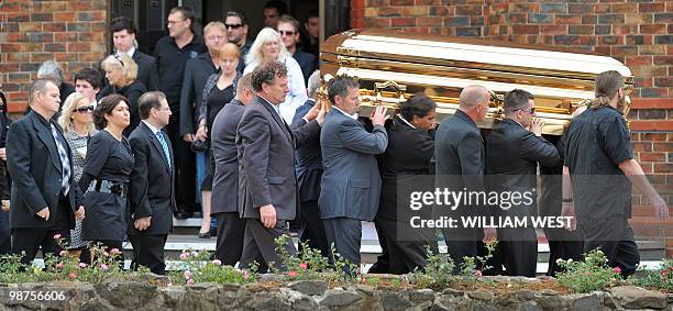 Roberta Williams , ex-wife of slain gangland killer Carl Williams and his father George , follow the gold-plated coffin out of the church as it...