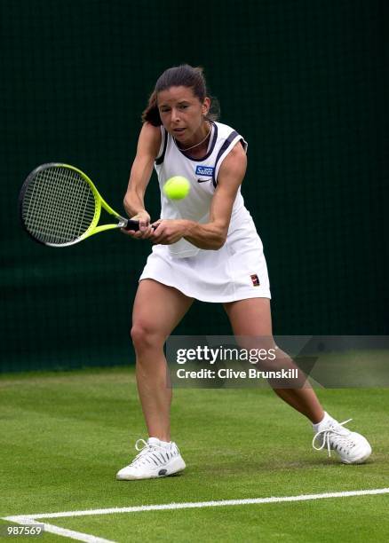 Karen Cross of Great Britain in action against Lisa Raymond of the USA during the women's second round of The All England Lawn Tennis Championship at...
