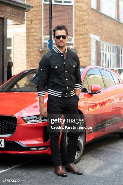Model David Gandy wears a Dolce and Gabbana jacket and Carmina shoes during London Fashion Week Men's on June 10, 2018 in London, England.