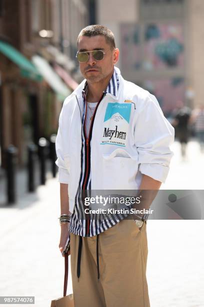 Style Director at WWD Alex Badia wears a Willy Chavarria jacket, Dior sunglasses, Andrea Pompilio shirt, Margaret Howell trousers during London...