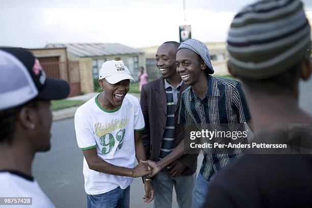 Thami Nkosi, a 29-year old activist, talks to friends outside his house on January 15 in Soweto, South Africa. Thami is a gender justice activist and...