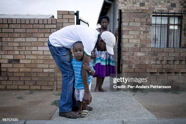 Thami Nkosi, a 29-year old activist, plays with his son Tumi on January 15 in Soweto, South Africa. Thami is a gender justice activist and often...