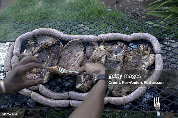 Thami Nkosi, a 29-year old activist, makes a barbecue for friends during a house party on January 16 in Soweto, South Africa. Thami is a gender...