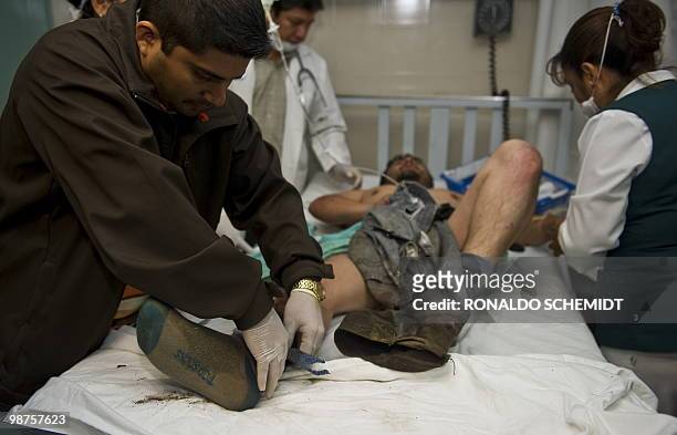 Mexican photographer David Cilia is helped by doctors at a hospital in Santiago Juxtlahuaca, Mexico on April 30, 2010. Cilia escaped an ambush by...