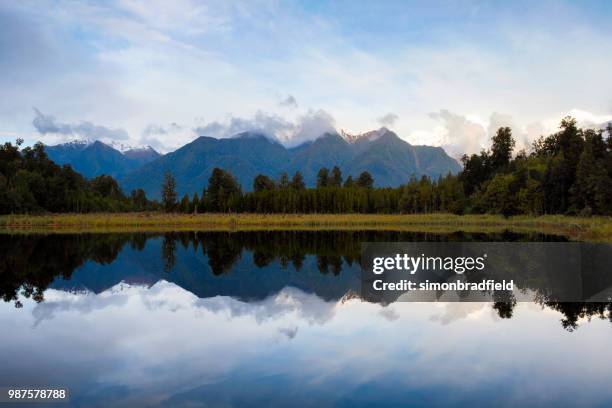 evening light at lake matheson, new zealand - westland national park stock pictures, royalty-free photos & images