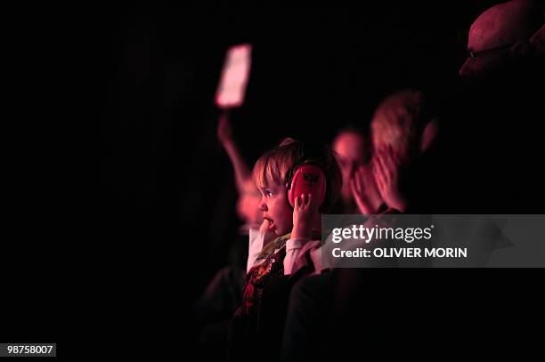 Boy wears ear muffs for hearing protection during the concert of Finnish heavy metal band for children, Hevisaurus, in Hameenlinna on April 17, 2010....
