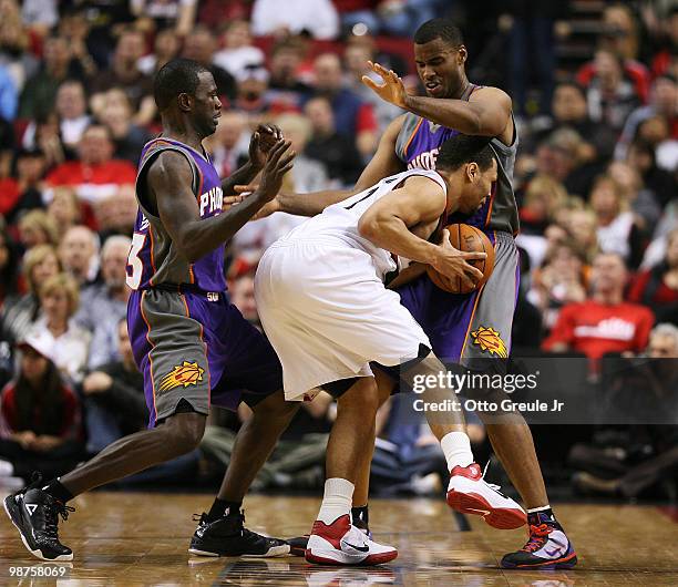 Brandon Roy of the Portland Trail Blazers is swarmed by Jason Richardson and Jarron Collins of the Phoenix Suns during Game Six of the Western...