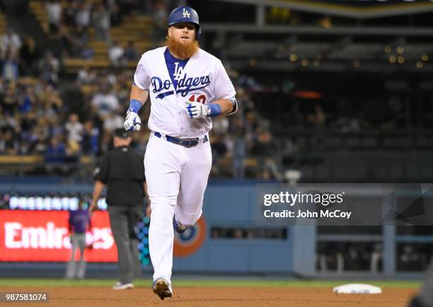 Justin Turner of the Los Angeles Dodgers rounds second base after hitting a home run agains the Colorado Rockies in the ninth inning at Dodger...