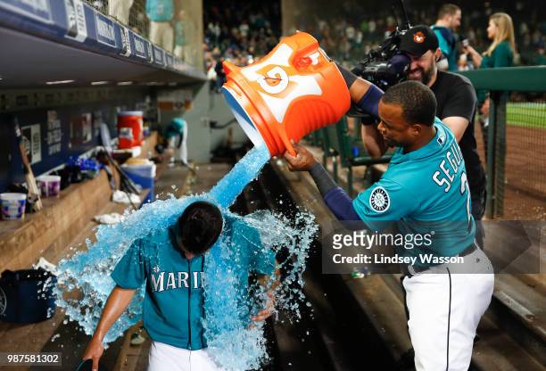 Jean Segura of the Seattle Mariners dumps ice on Marco Gonzales, who pitches his first career complete game against the Kansas City Royals at Safeco...