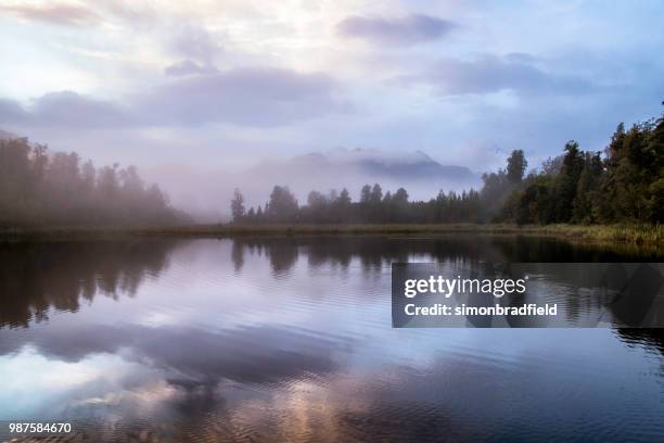 dawn breaks over lake matheson in new zealand - westland national park stock pictures, royalty-free photos & images