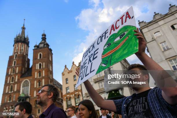 Man holds a placard saying "F#uck off ACTA, we are full " during a protest against the implementation of ACTA 2 in European Union. On June 20th, The...