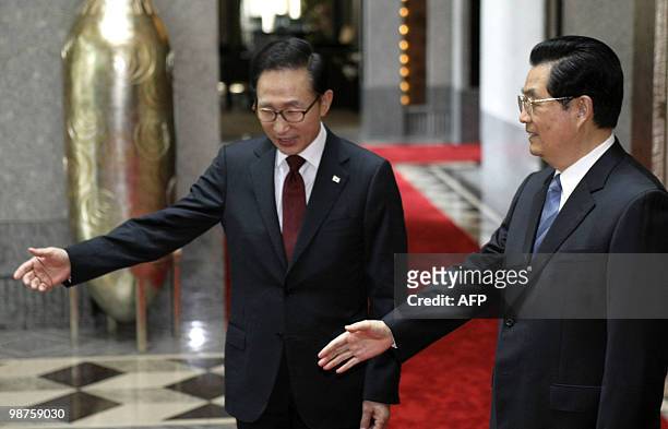 Chinese President Hu Jintao and South Korean President Lee Myung-Bak shake gesture prior to their meeting in Shanghai on April 30, 2010. Lee is...