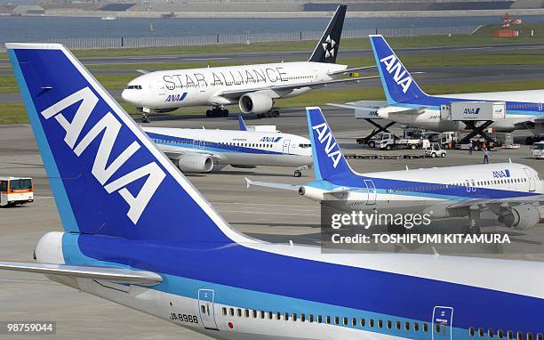 All Nippon Airways jetliners stand at the Haneda airport in Tokyo, on April 30, 2010. ANA incurred a group net loss of 57.4 billion yen in the year...