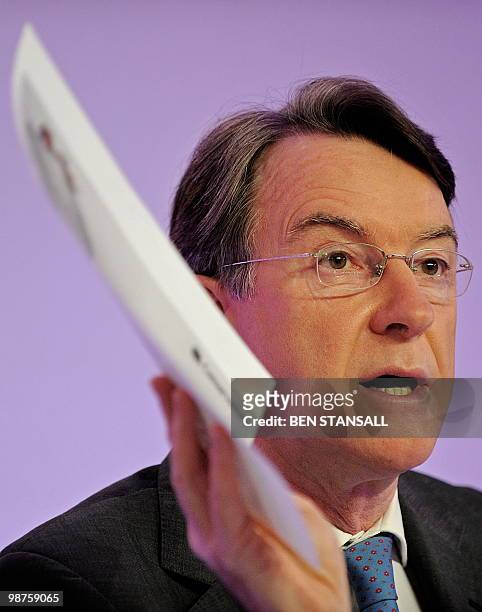 British Business Minister Peter Mandelson holds a copy of the oppostion Conservative party's manifesto during a press conference with Prime Minister...