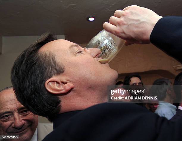 Conservative Party Leader David Cameron finishes a pint of Guinness at the Three Suga Loaves following the second live televised debate between the...