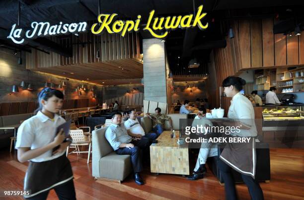 Customers relax at the 'Kopi Luwak' coffee shop in Jakarta on April 30, 2010. Kopi Luwak or Civet Coffee is made from beans of coffee berries which...