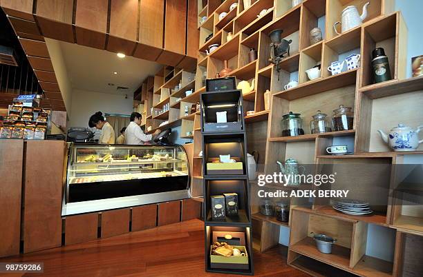 Ornaments and packs of 'Kopi Luwak' coffee are displayed at a shop in Jakarta on April 30, 2010. Kopi Luwak or Civet Coffee is made from beans of...