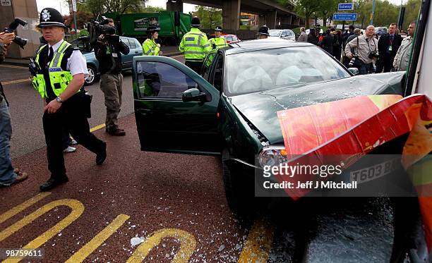 Police gather at the scene of a car crash at a bus shelter next to where Gordon Brown and his cabinet were launching a poster campaign on April 30,...