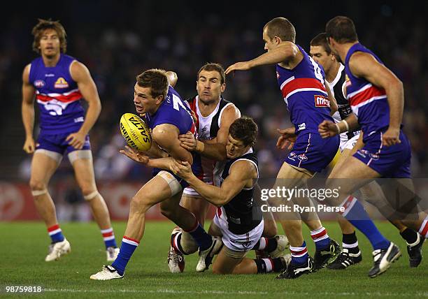 Shaun Higgins of the Bulldogs is tackled by Steven King and Nick Dal Santo of the Saints during the round six AFL match between the Western Bulldogs...