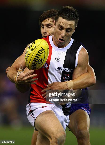 Stephen Milne of the Saints is tackled by Ryan Griffin of the Bulldogs during the round six AFL match between the Western Bulldogs and the St Kilda...