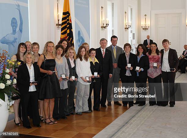 German President Horst Koehler and German Defense Minister Karl-Theodor zu Guttenberg pose with members of the German deaf national women's football...