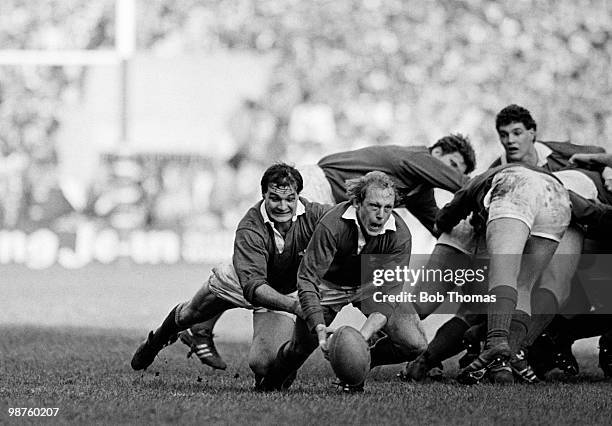 Ireland scrum-half Robbie McGrath is tackled by Wales scrum-half Terry Holmes during the Rugby Union International match held at Cardiff Arms Park on...